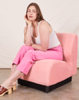 Work Pants in Bubblegum Pink on Allison wearing Tank Top in vintage tee off-white sitting in pink upholstered chair