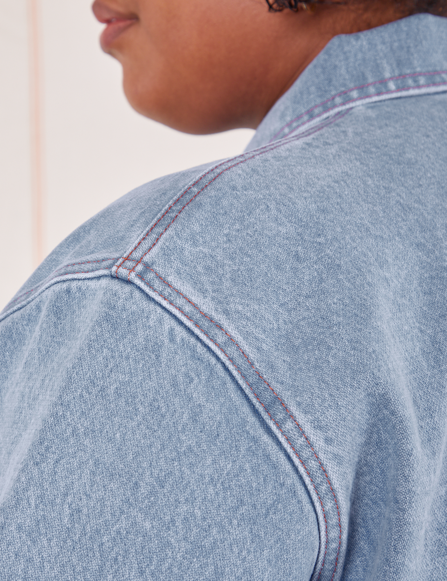 Indigo Denim Work Jacket in Light Wash  shoulder close up on Morgan