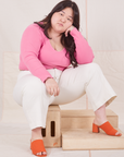  Long Sleeve V-Neck Tee in Bubblegum on Ashley wearing vintage tee off-white Western Pants sitting on wooden crate