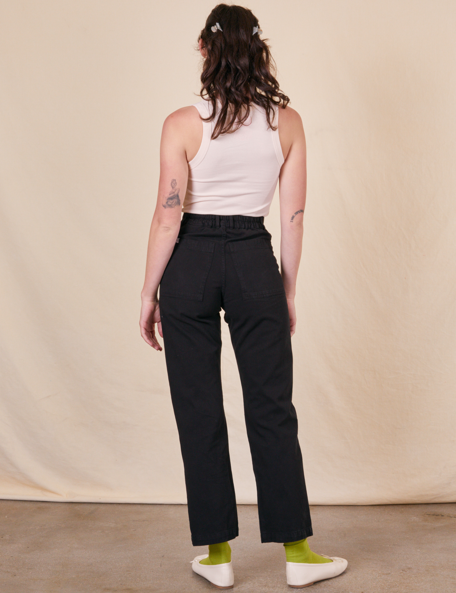 Back view of Work Pants in Basic Black and Tank Top in vintage tee off-white on Alex