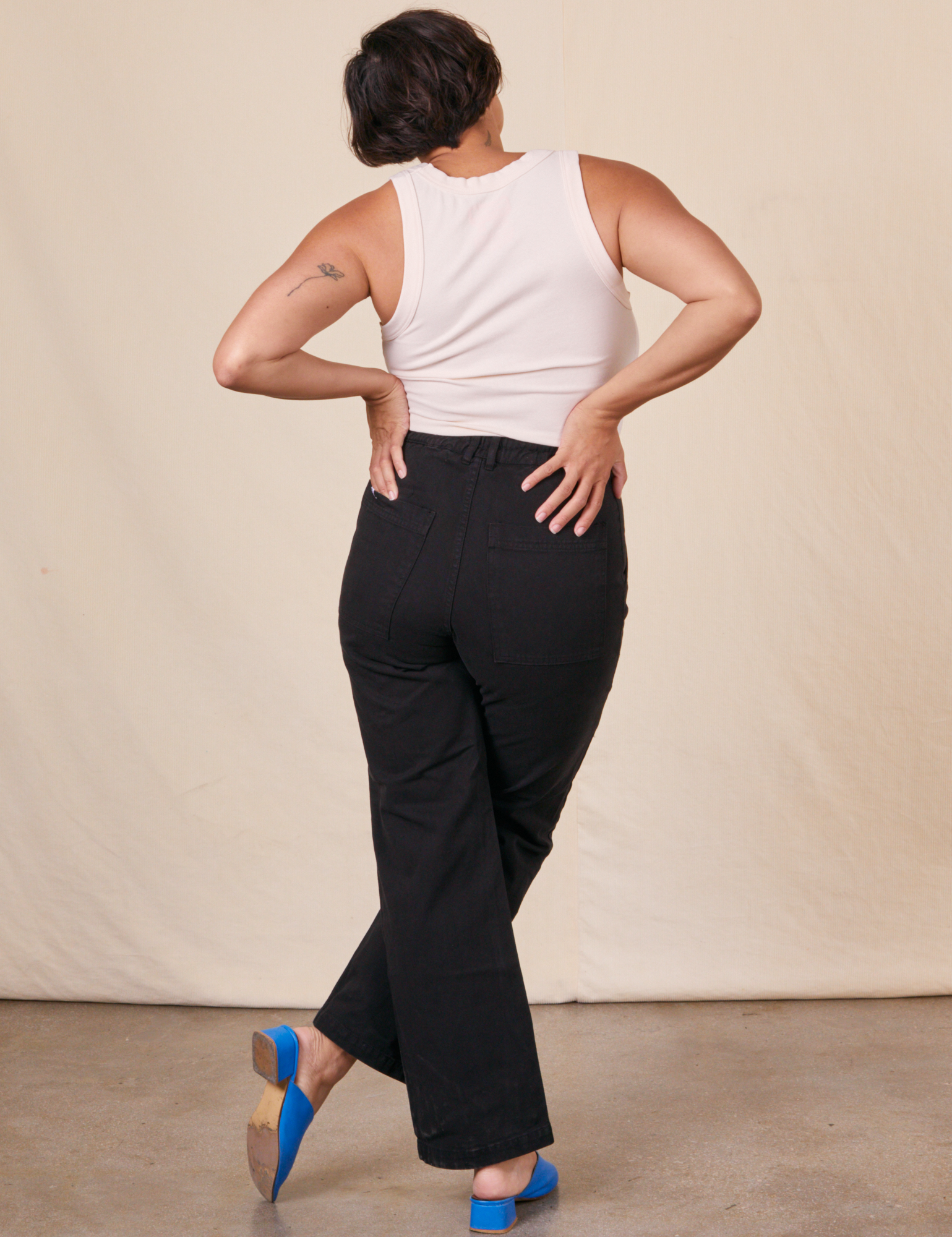 Back view of Work Pants in Basic Black and vintage off-white Tank Top on Tiara