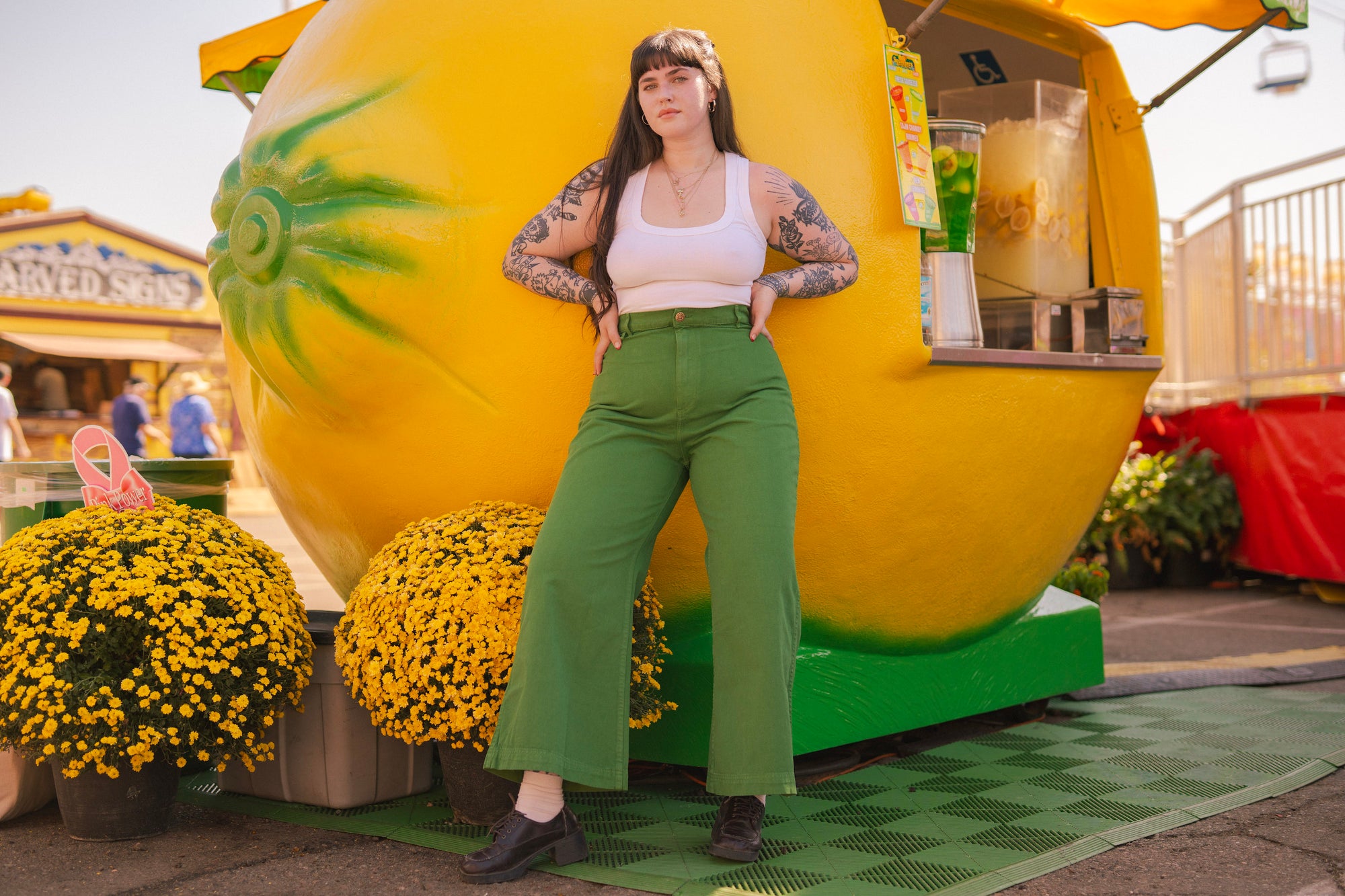 Sydney is wearing Cropped Tank Top in Vintage Off-White and Bell Bottoms in Lawn Green