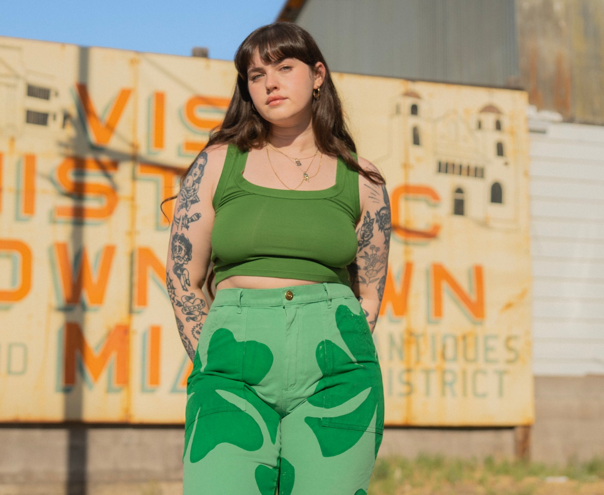 Sydney is wearing Cropped Tank Top in Lawn Green and Icon Work Pants in Clover