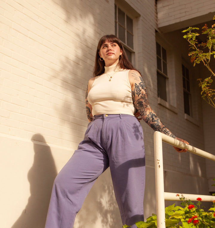Sydney wearing Sleeveless Essential Turtleneck in Vintage Off-White and Heritage Trousers in Faded Grape