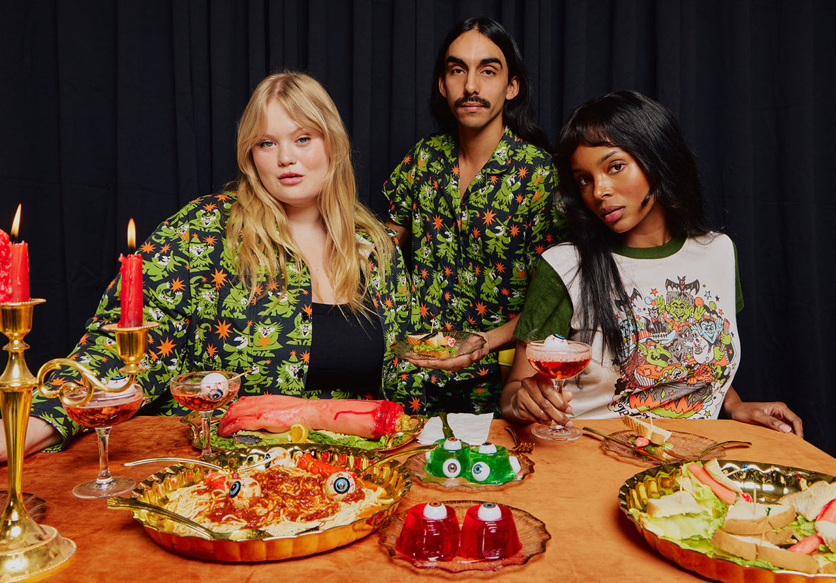Juliet is wearing the Spellbound Cropped Overshirt, Anthony is wearing the Spellbound Short Sleeve Jumpsuit and Kandia is wearing the Vintage Halloween Tee