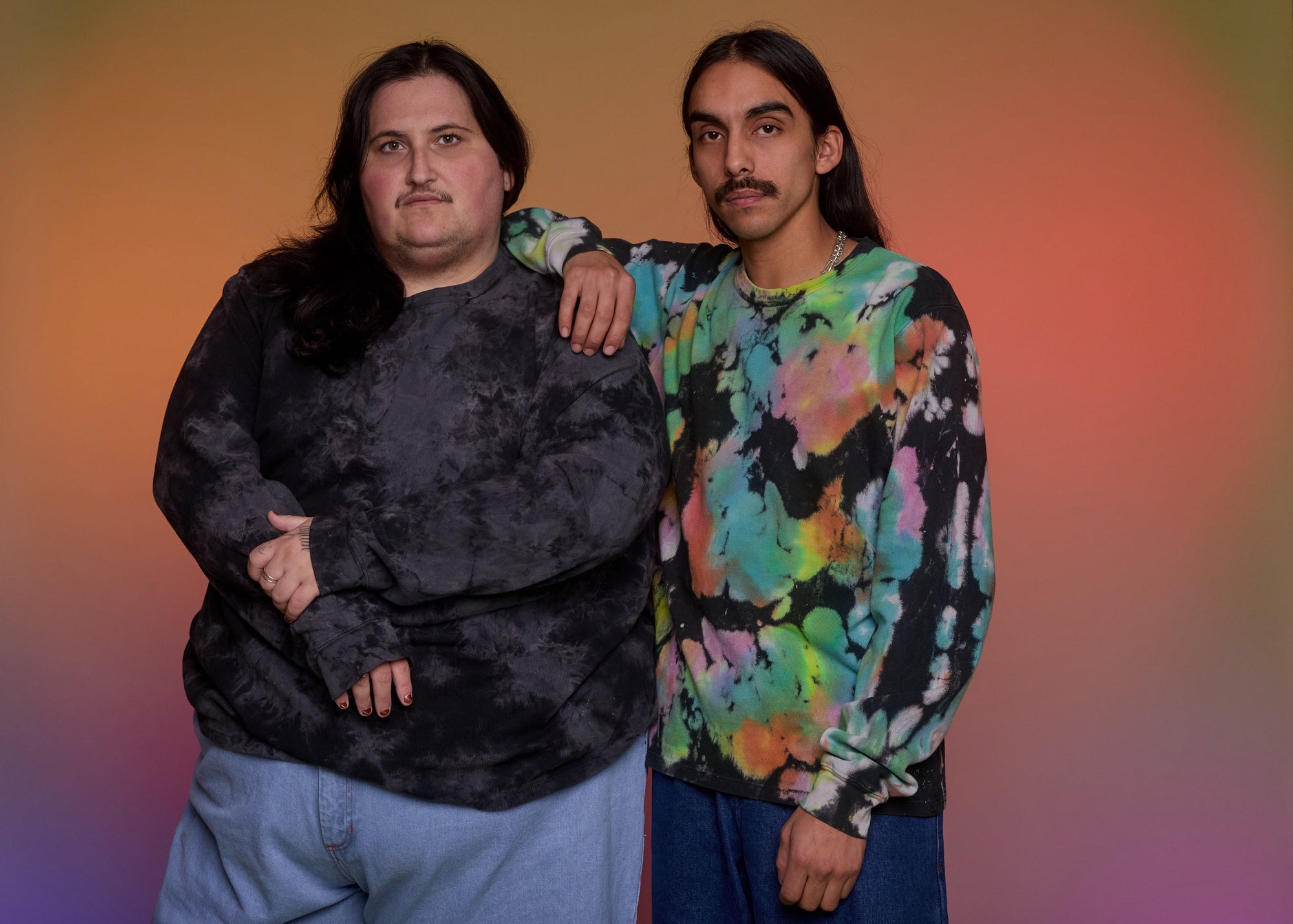 Sam is wearing Long Sleeve Burly Tee in Rainbow and Anthony is wearing Long Sleeve Burly Tee in Black.