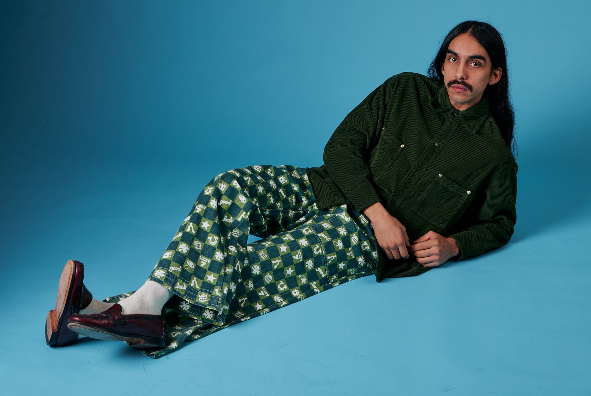 Anthony is wearing Printed Action Pants in Lucky (Green) and Cropped Corduroy Overshirt in Evergreen