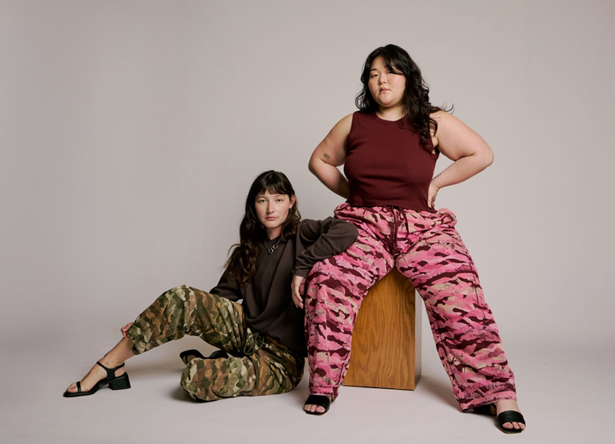 Alex is wearing Camo Drop Pocket Pants in Surplus Green paired with a Long Sleeve Burly Tee in Espresso Brown. Ashley is wearing Camo Drop Pocket Pants in Red Wine paired with a Muscle Tee in Red Wine