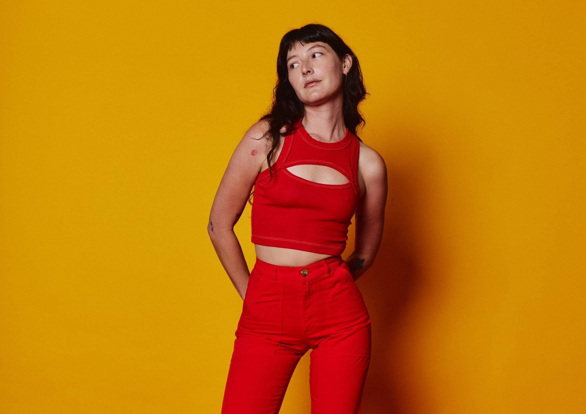 Alexandra Skye is wearing Porthole Tank in Mustang Red and Work Pants in Mustang Red. 
