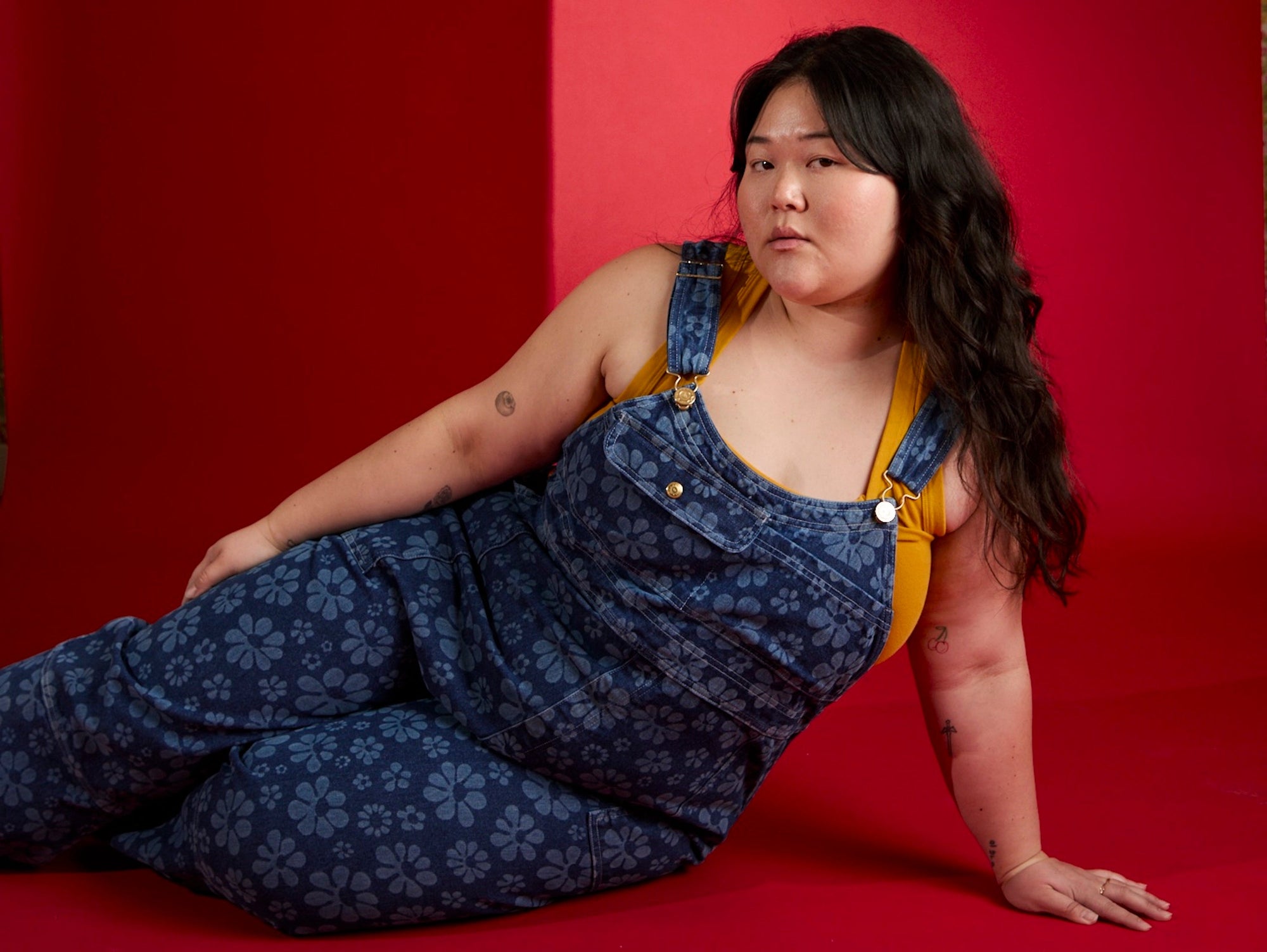 Ashley is wearing Carpenter Overalls in Lazy Daisy and Cropped Tank in Mustard Yellow