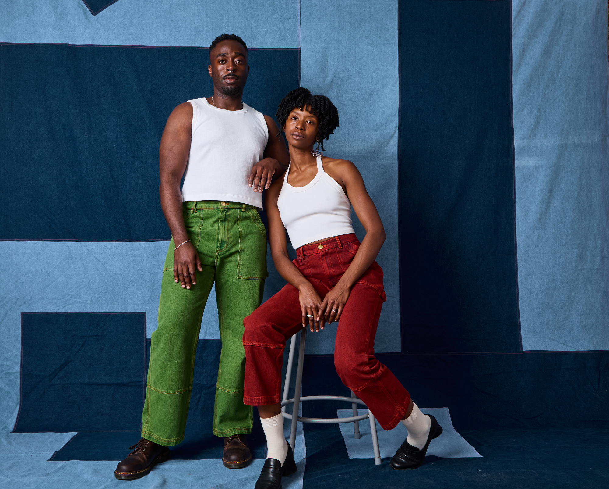 Cheyann is wearing Overdyed Carpenter Jeans in Mustang Red and a Halter Top in Vintage Tee Off-White. Eli is watching Overdyed Carpenter Jeans in Gross Green and Muscle Tee in Vintage Tee Off-White