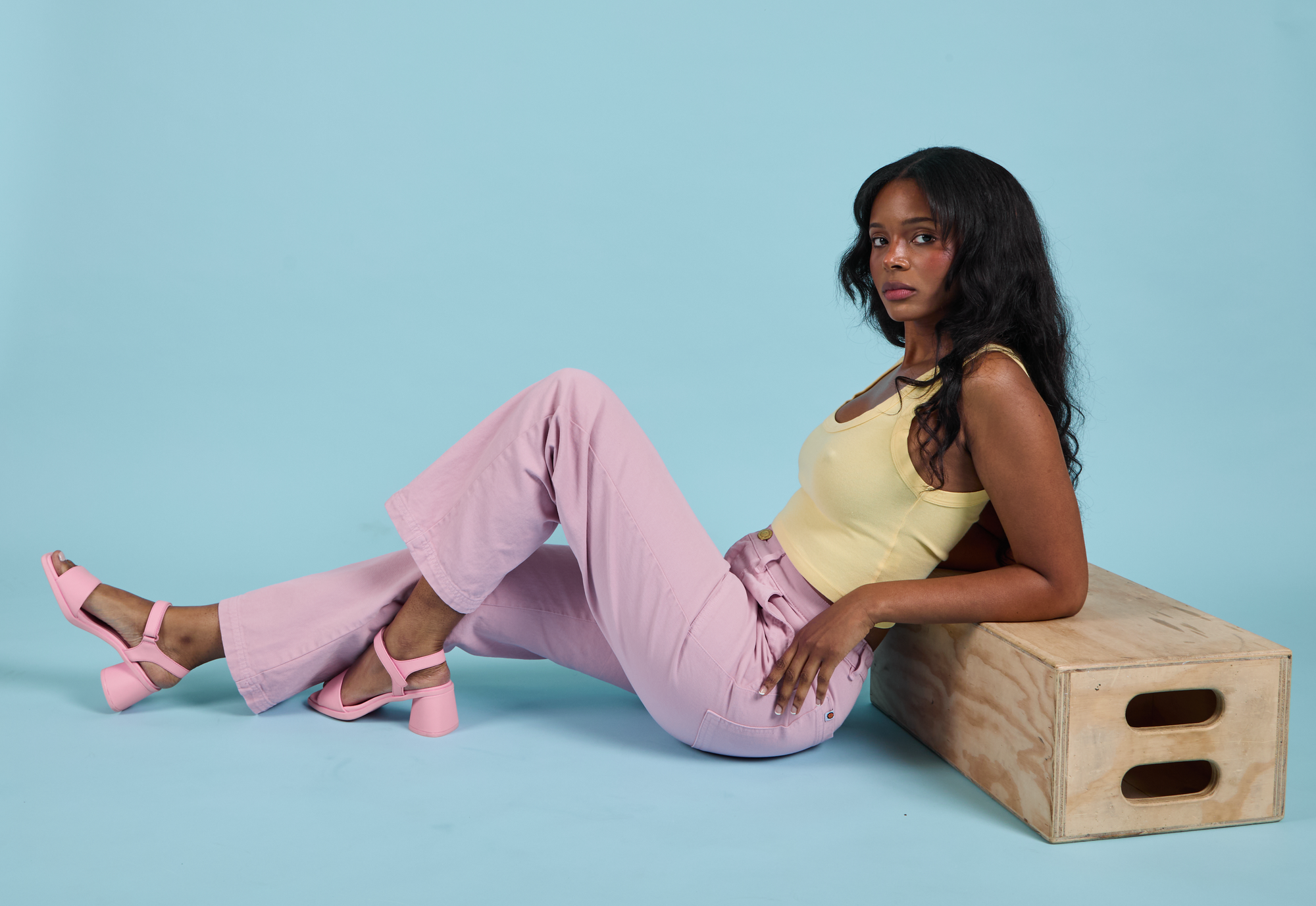 Kandia is wearing Cropped Tank in Butter Yellow and Work Pants in Lilac.