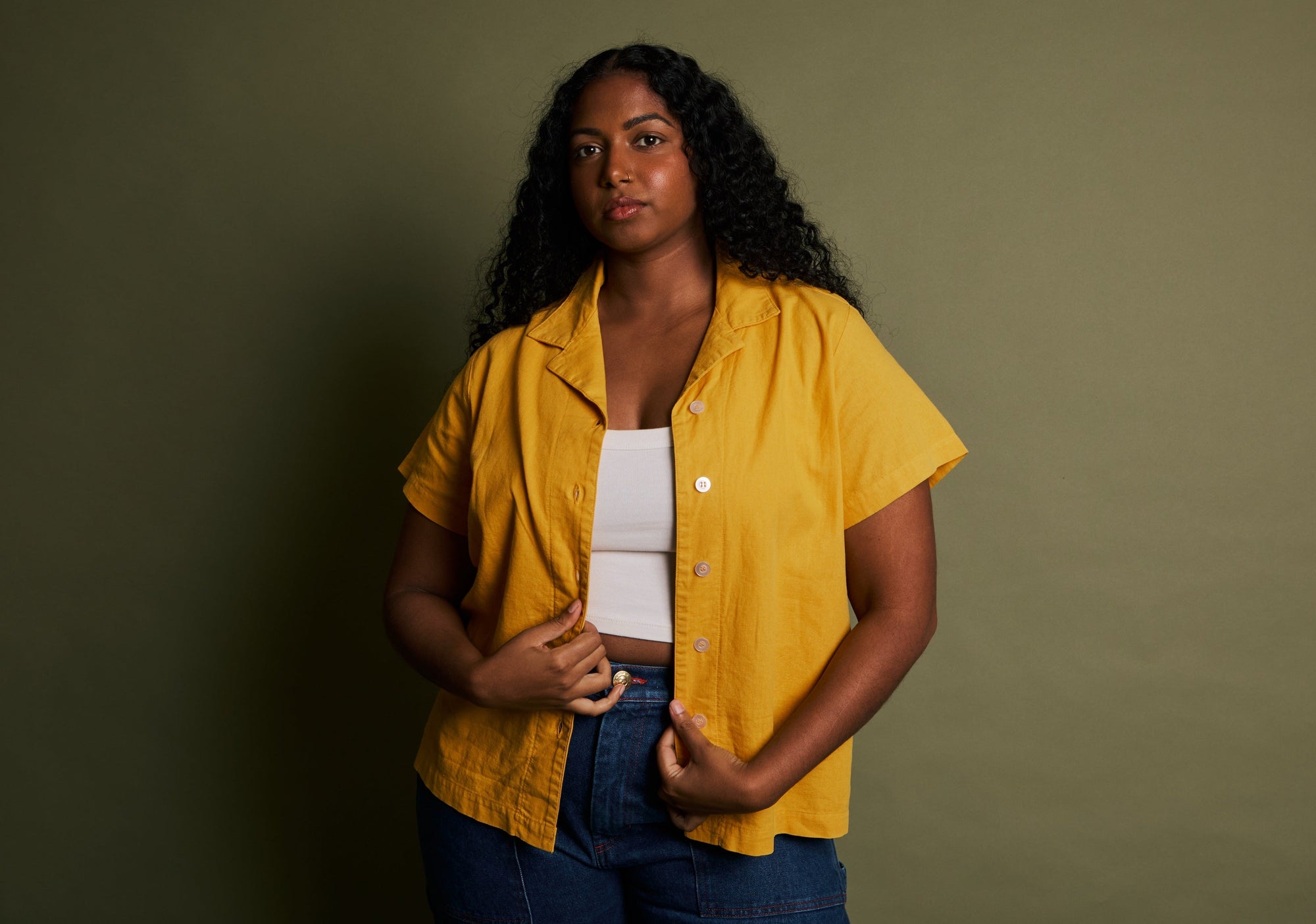 Meghna is wearing Pantry Button-Up in Mustard Yellow, Cropped Tank in Vintage Tee White and Carpenter Jeans in Dark Wash