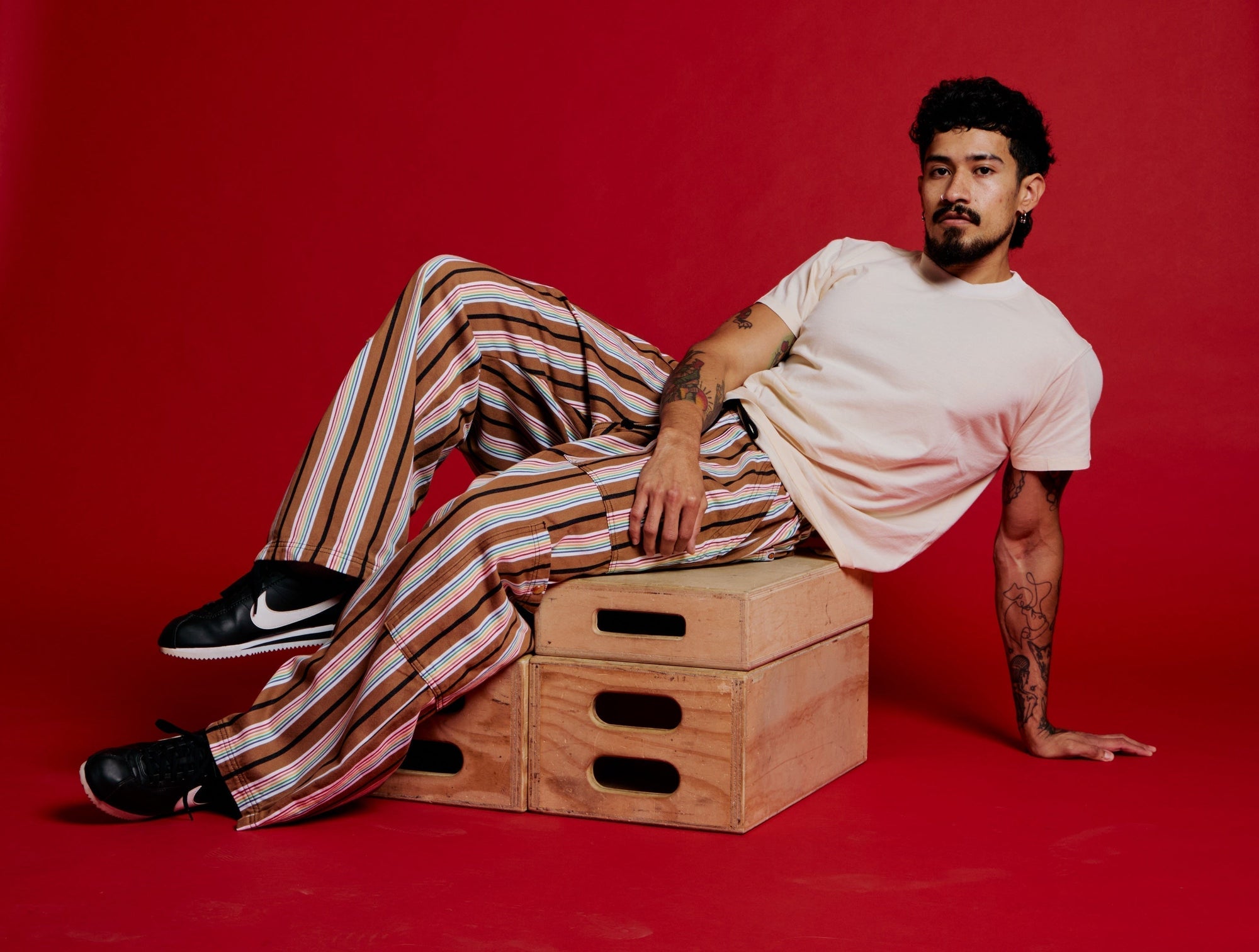 Jesse is wearing Striped Drop Pocket Pants in Retro Rainbow and The Organic Vintage Tee in Vintage Off-White