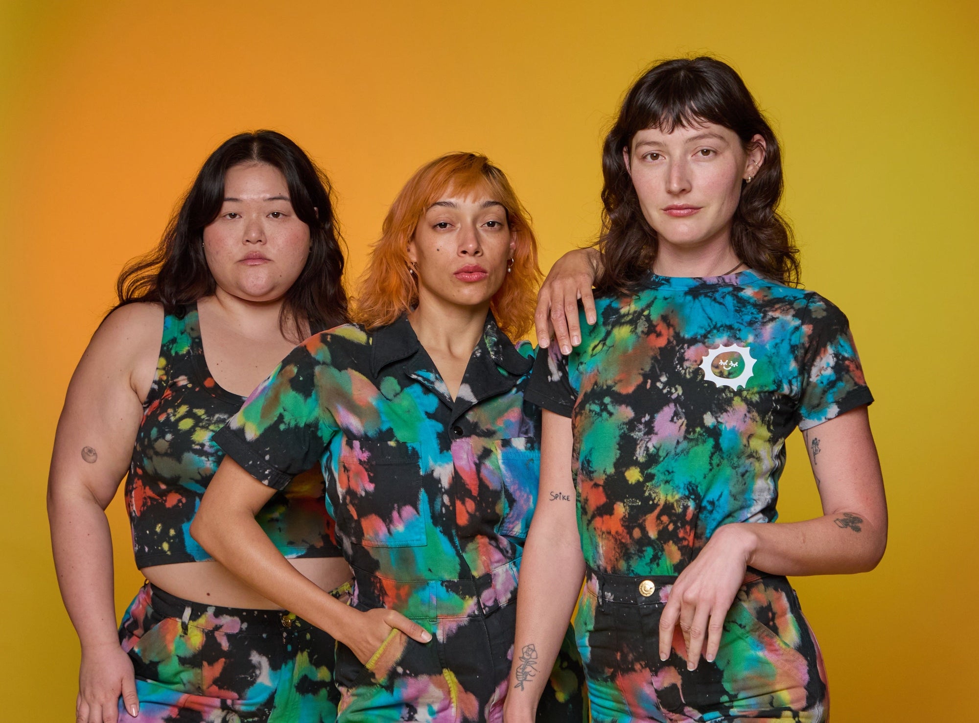 Alex is wearing Rainbow Magic Waters Tee, Ashley is wearing Rainbow Magic Waters Work Pants, and Tiara is wearing Rainbow Magic Waters Jumpsuit