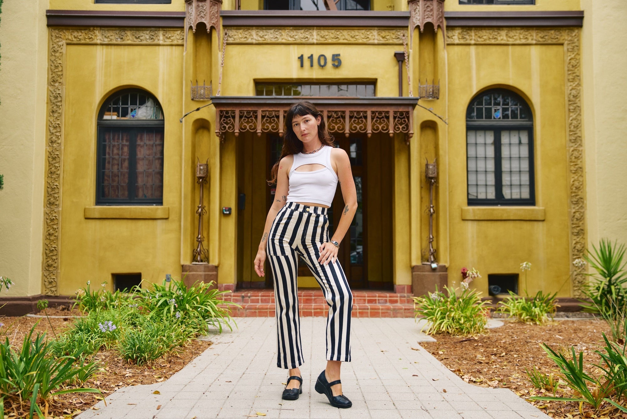 Alexandra Skye is wearing Black Stripe Work Pants in Natural and Porthole Tank in Vintage Tee White