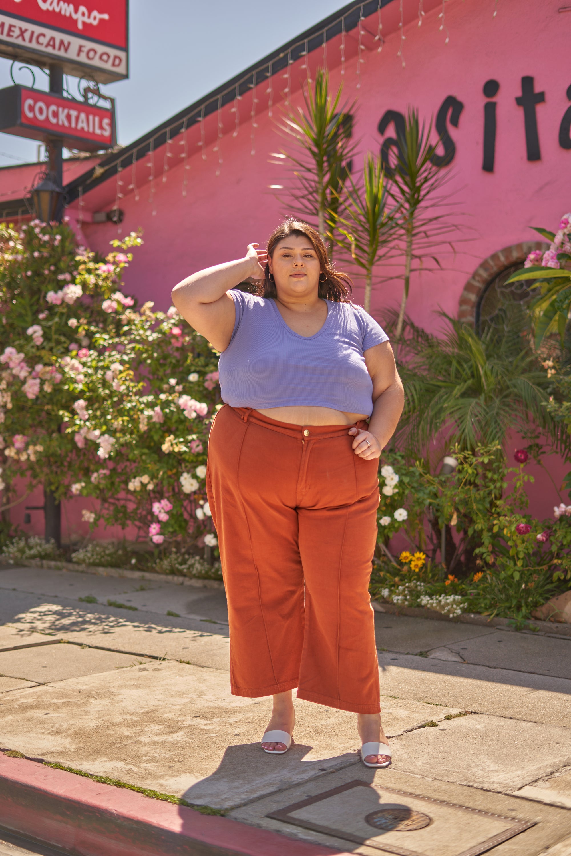 Sarita wearing Short Sleeve V-Neck Tee in Faded Grape and Western Pants in Burnt Terracotta