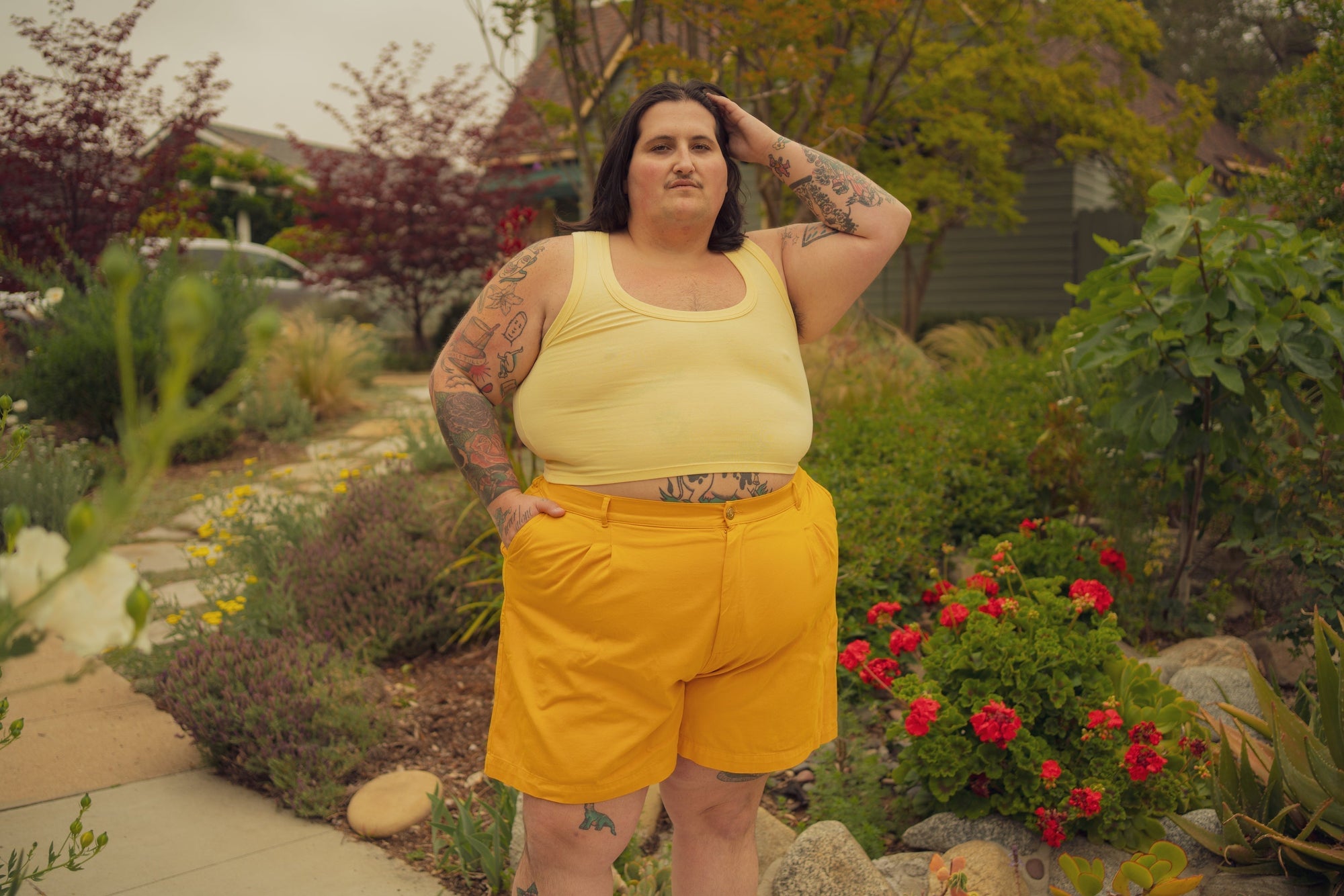 Sam is wearing Cropped Tank Top in Butter Yellow and Trouser Shorts in Mustard Yellow