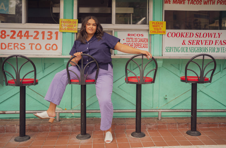 Alicia is wearing Pantry Button-Up in Navy and Western Pants in Faded Grape
