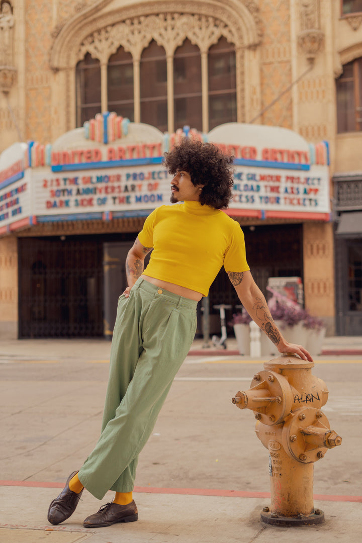 Jesse wearing 1/2 Sleeve Essential Turtleneck in Golden Yellow and Trousers in Sage
