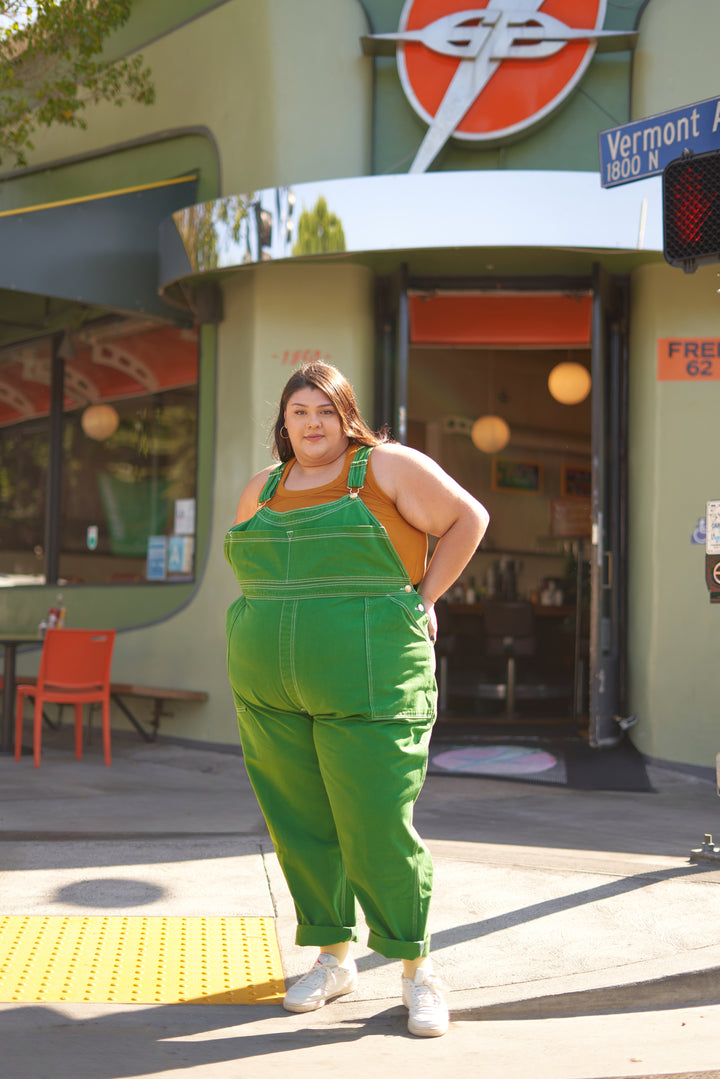 Sarita wearing Overalls in Forest Green and Tank Top in Spicy Mustard