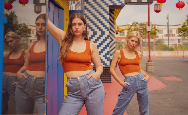 Allison and Madeline are both wearing the Cropped Tank Top in Burnt Orange and Railroad Stripe Carpenter Jeans