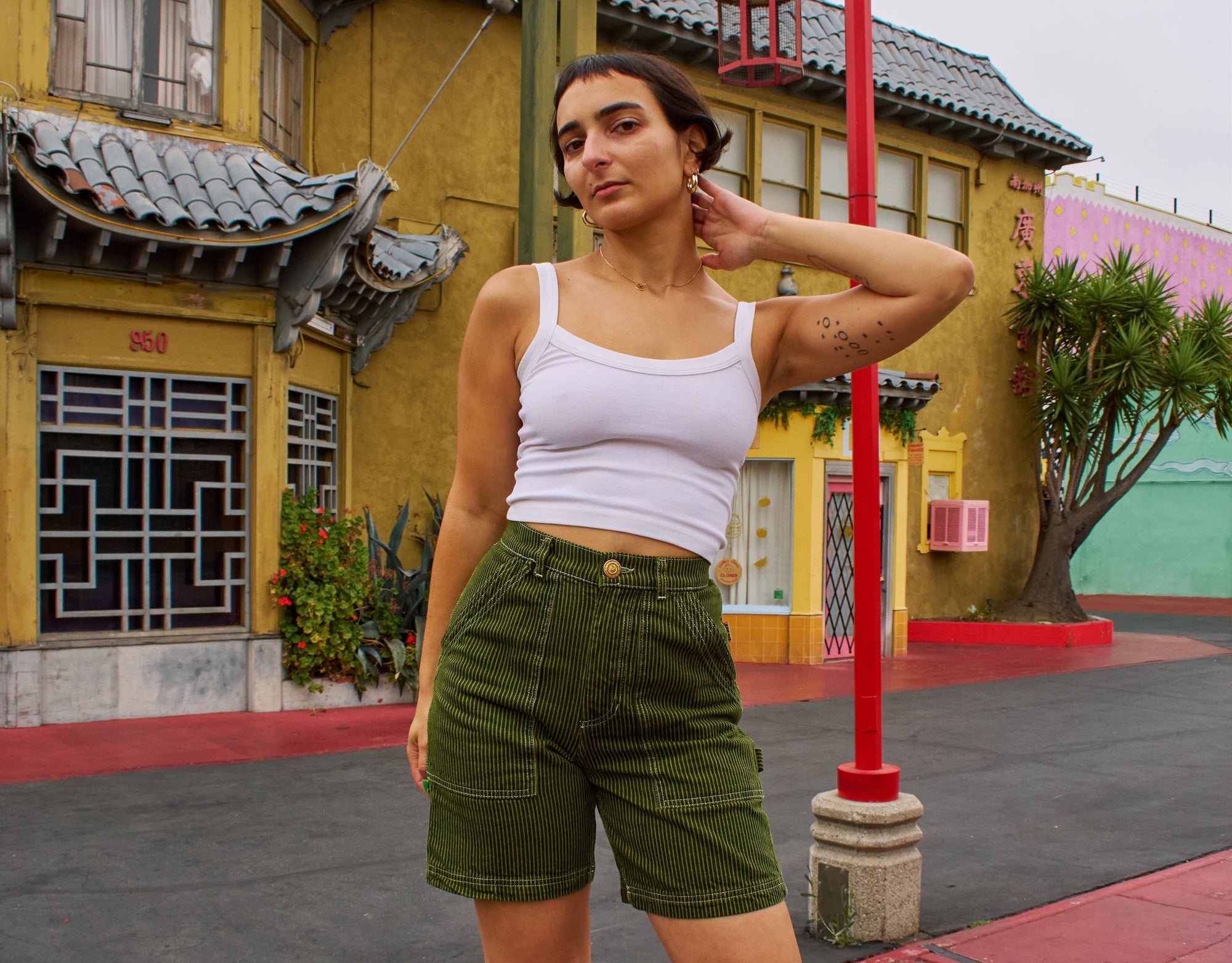 Soraya is wearing Railroad Carpenter Shorts in Summer Olive and Cropped Cami in Vintage Tee Off-White