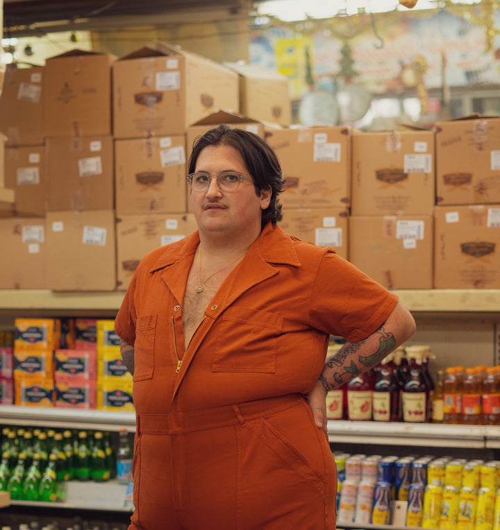 Sam Wearing Short Sleeve Jumpsuit in Burnt Terracotta