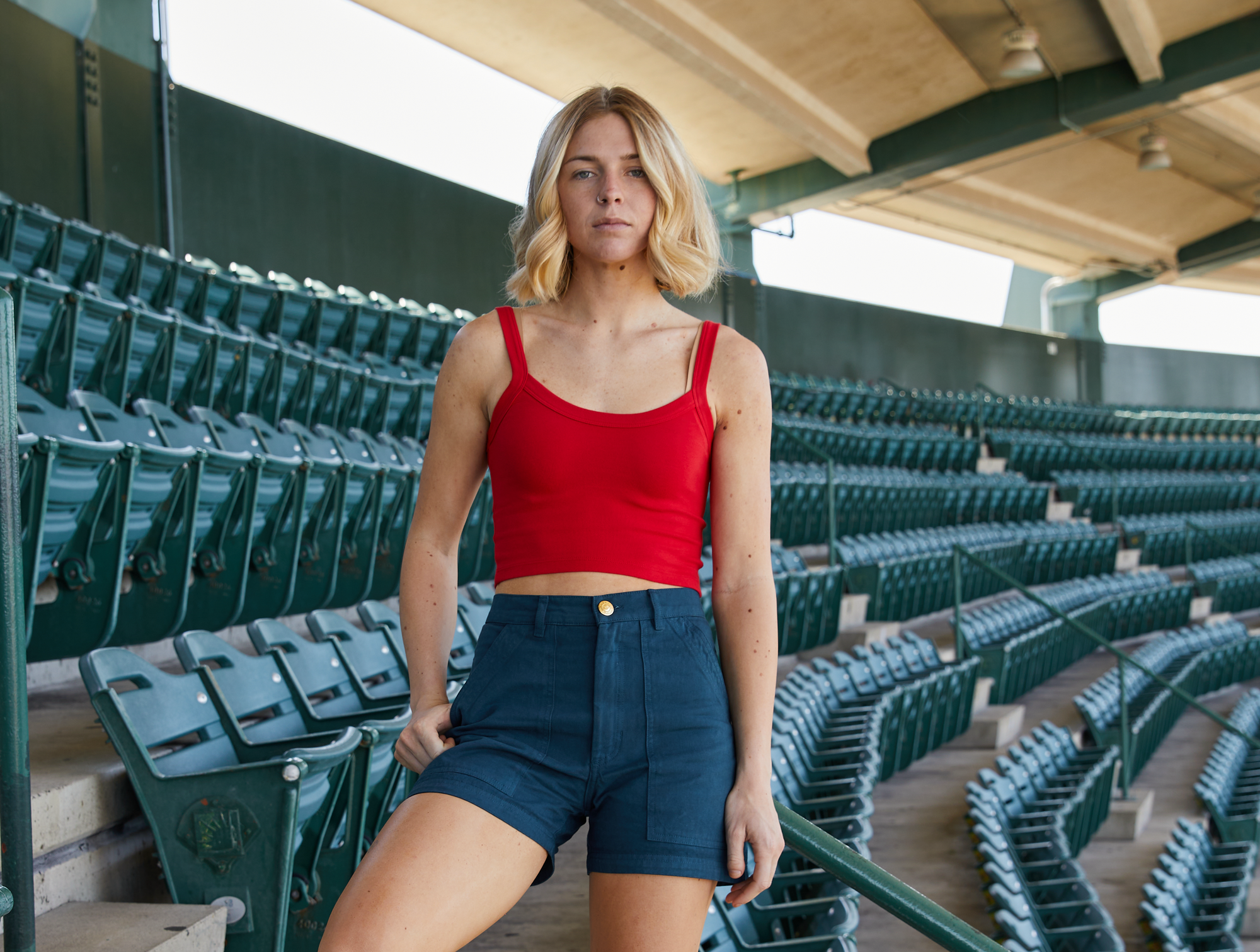 Puppy is wearing Cropped Cami in Mustang Red and Work Shorts in Lagoon