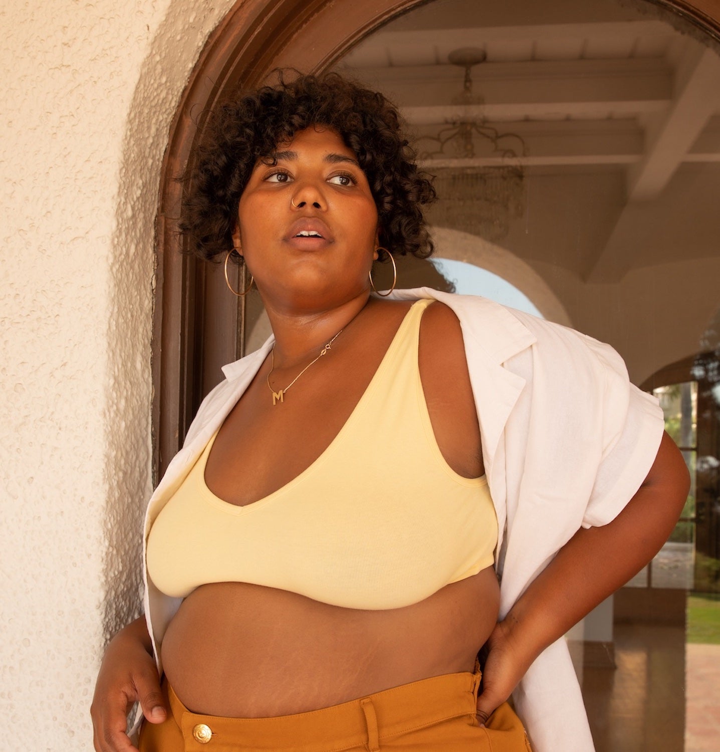 Morgan is wearing Pantry Button-Up in Vintage Off-White, Bralette in Butter Yellow, and Western Pants in Spicy Mustard