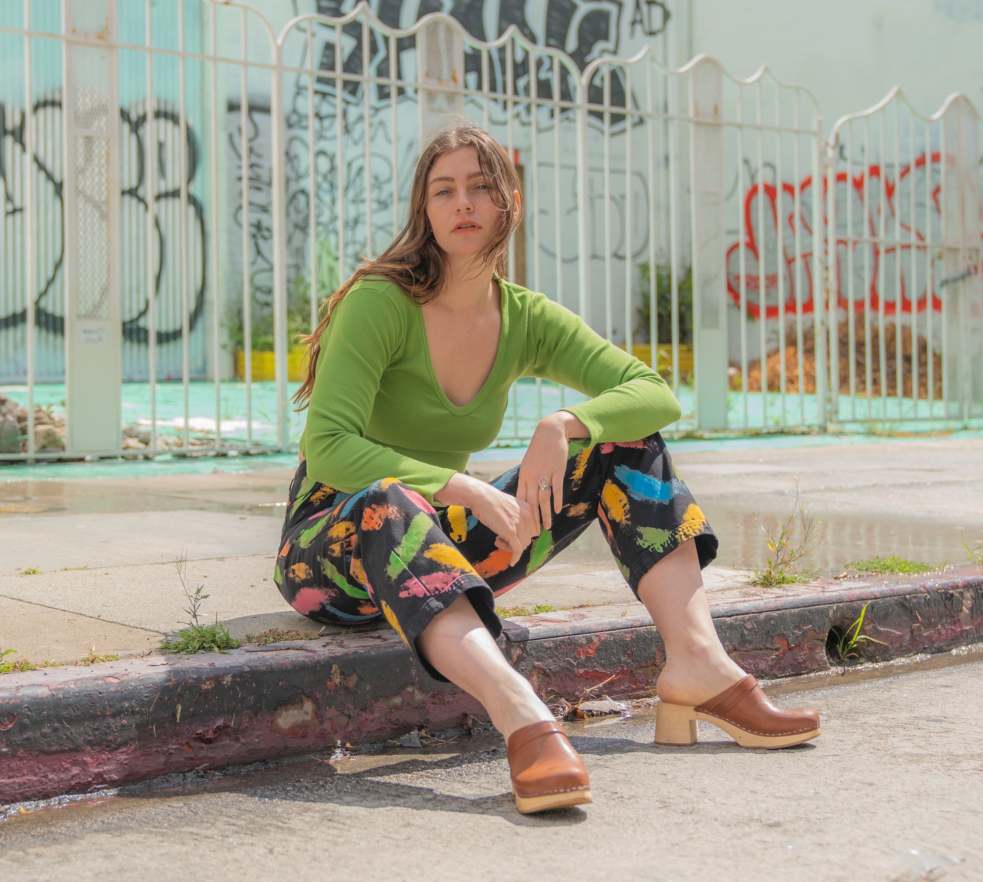 Allison is wearing Paint Stroke Work Pants and Long Sleeve V-Neck Tee in Bright Olive