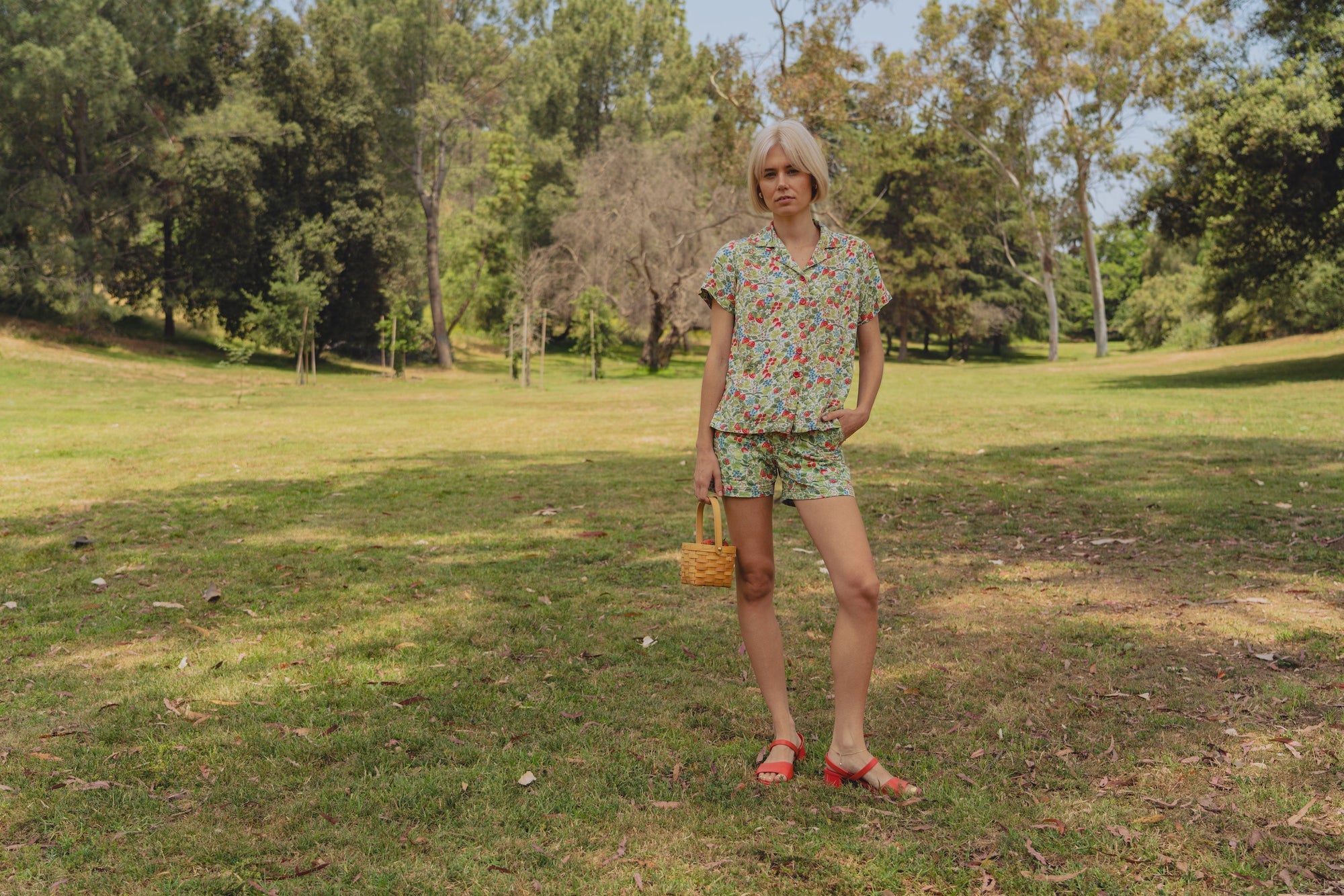 Madeline is wearing Off-White Strawberry Pantry Button-Up and Work Shorts in Off-White Strawberry