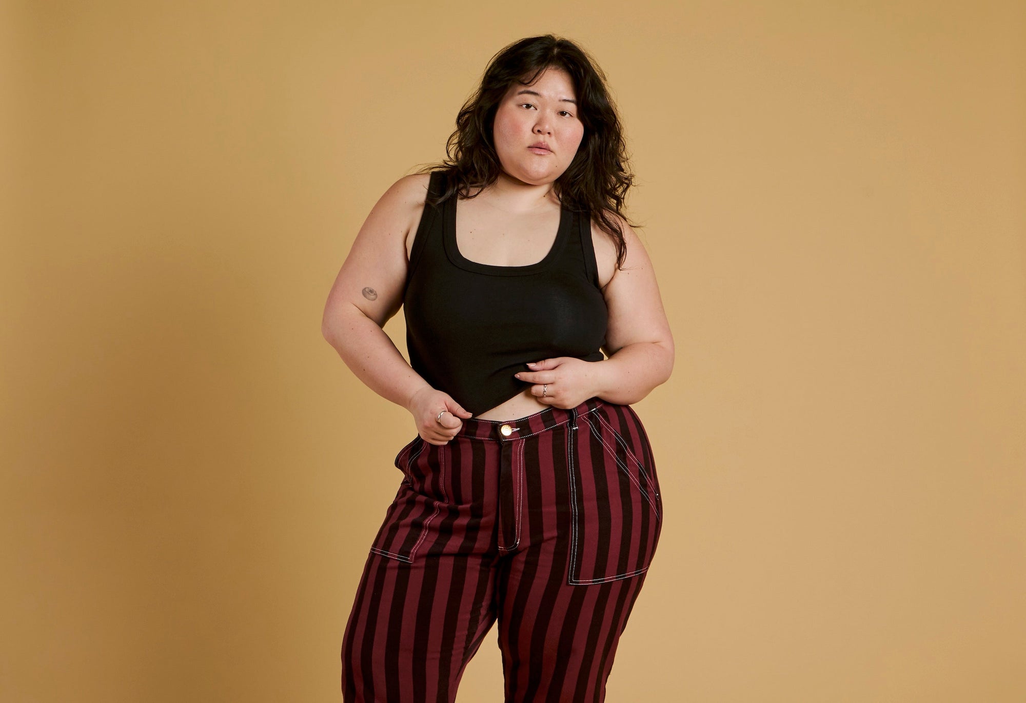 Ashley is wearing Black Stripe Work Pants in Red Wine and Cropped Tank in Basic Black
