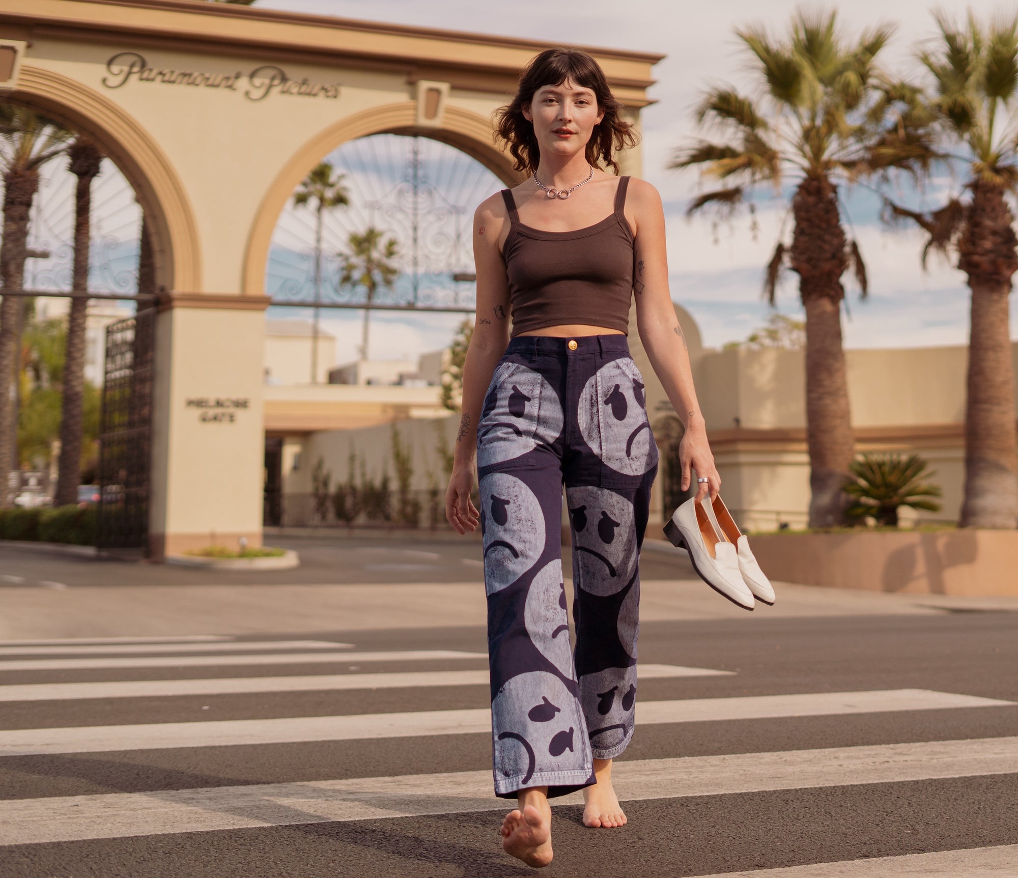 Alexandra Skye is wearing Icon Work Pants in Sad Face and Cropped Cami in Espresso Brown