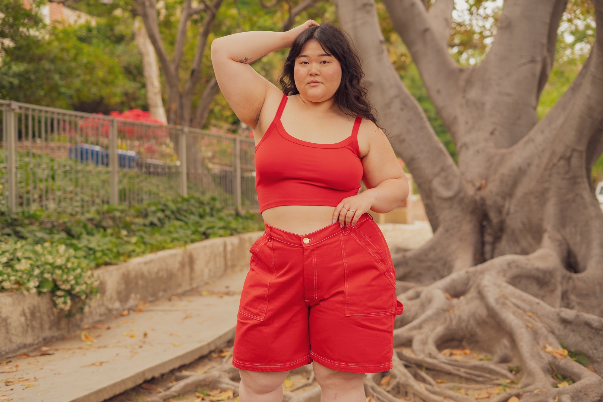 Ashley is wearing Cropped Cami in Mustang Red and Carpenter Shorts in Mustang Red