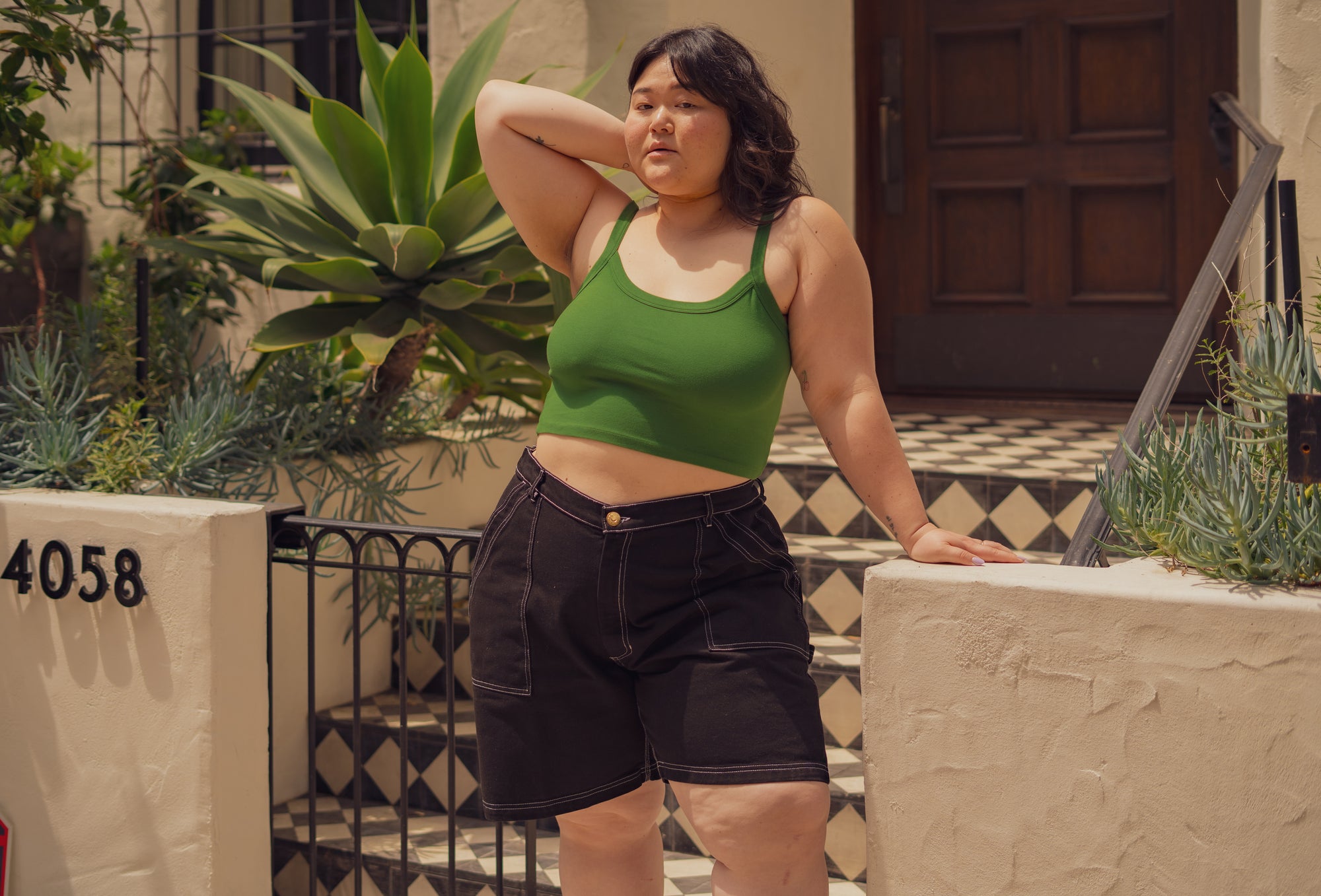 Ashley is wearing Carpenter Shorts in Black and Cropped Cami in Lawn Green