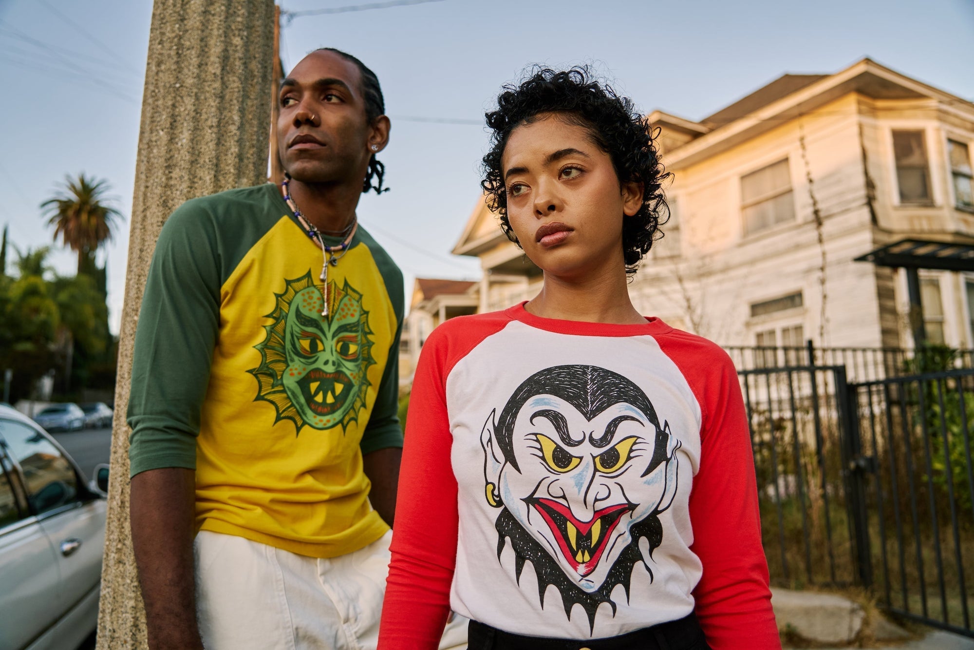 Jerrod is wearing the Raglan Tee in Creature and Work Pants in Vintage Tee White. Mika is wearing Raglan Tee in Dracula with Petite Heavyweight Trousers in Black