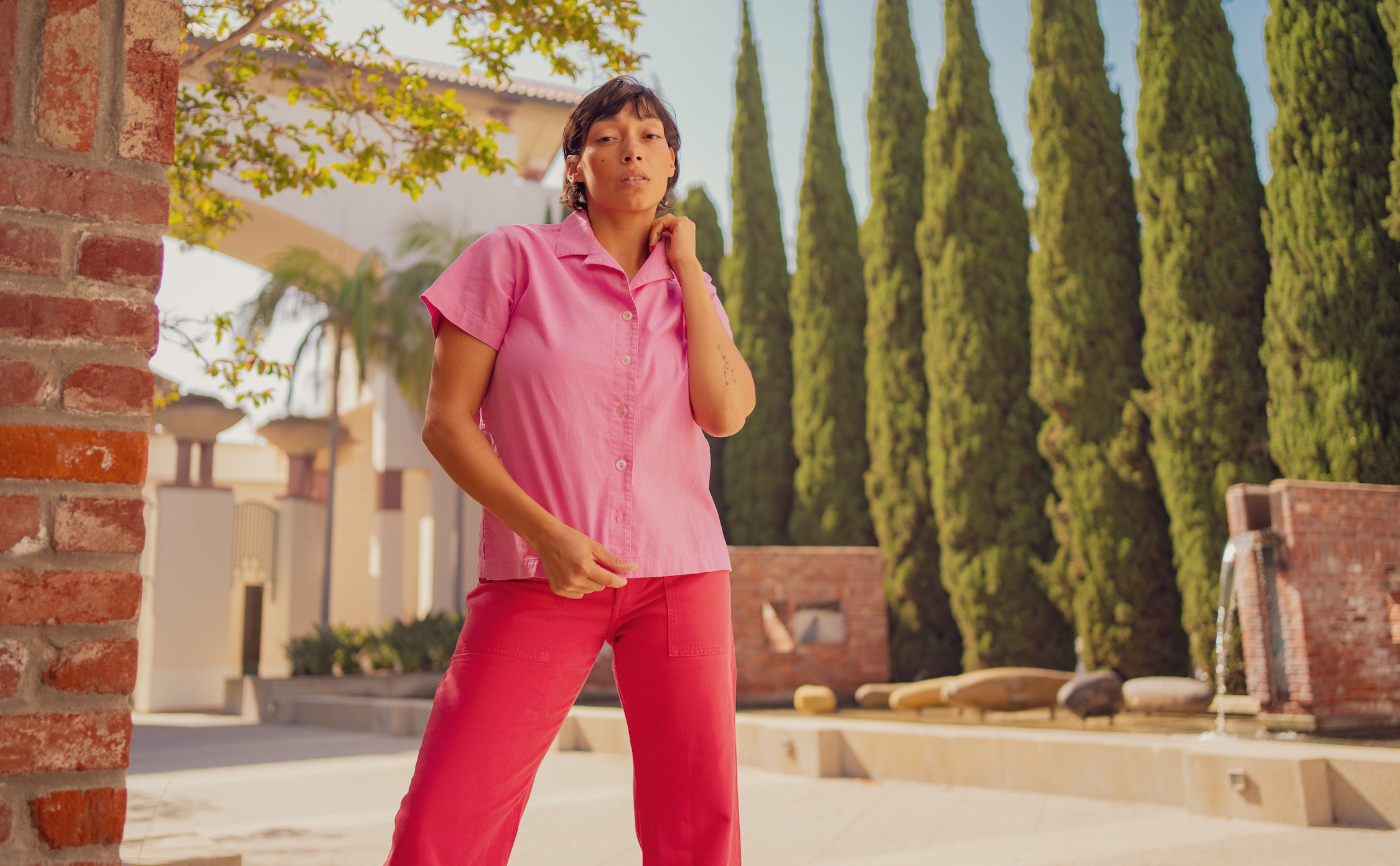 Tiara is wearing Pantry Button Up in Bubblegum Pink and Work Pants in Hot Pink