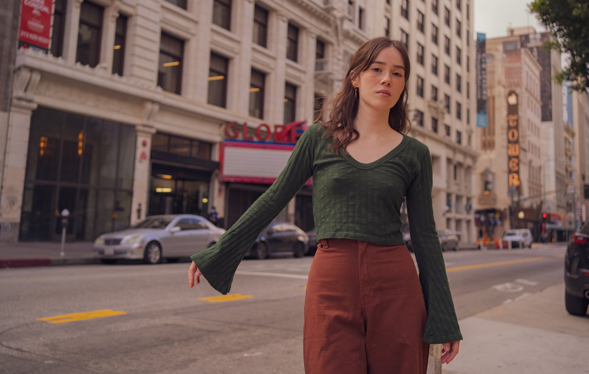 Hana is wearing Bell Sleeve Top in Swamp Green and Bell Bottoms in Fudgesicle