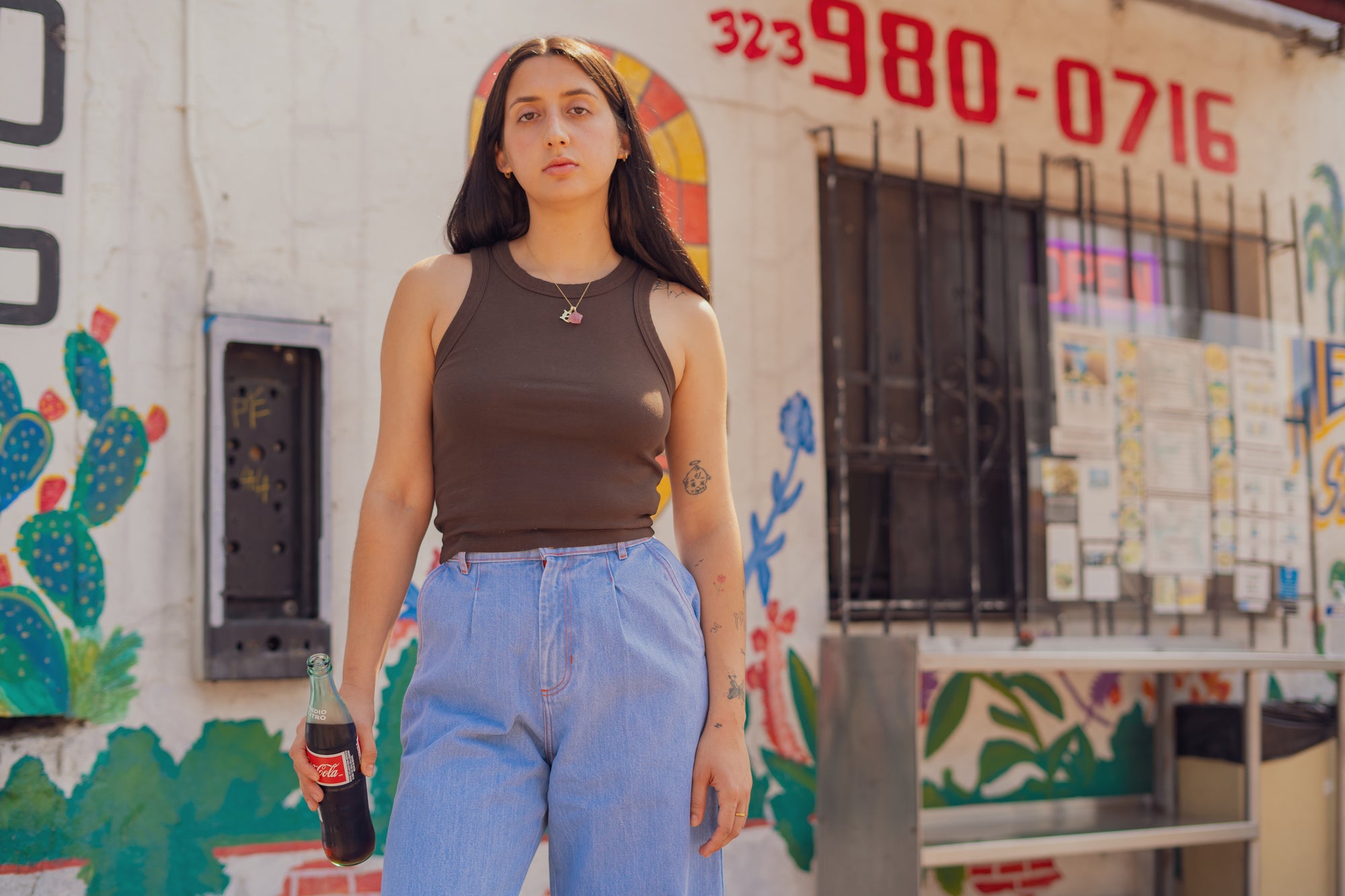Betty is wearing Racerback Tank in Espresso Brown and Indigo Wide Leg Trousers in Light Wash