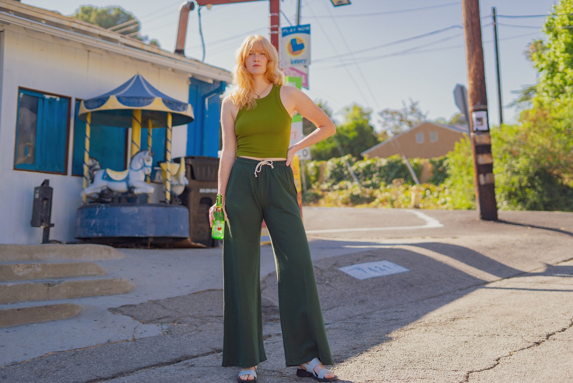 Margaret is wearing Racerback Tank in Summer Olive and Wide Leg Sweat Pants in Surplus Green