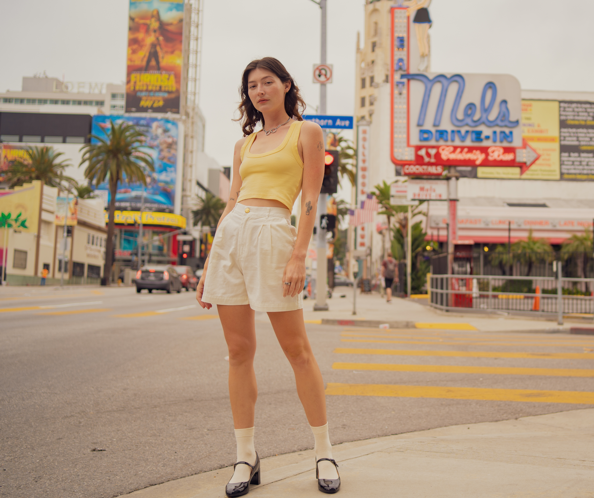 Alexandra Skye is wearing Cropped Tank Top in Butter Yellow and Trouser Shorts in Vintage Tee Off-White