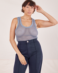 Tiara is 5'4" and wearing XS Mesh Tank Top in Periwinkle paired with navy Western Pants