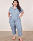 Ashley is 5’7” and wearing 1XL Petite Short Sleeve Jumpsuit in Periwinkle