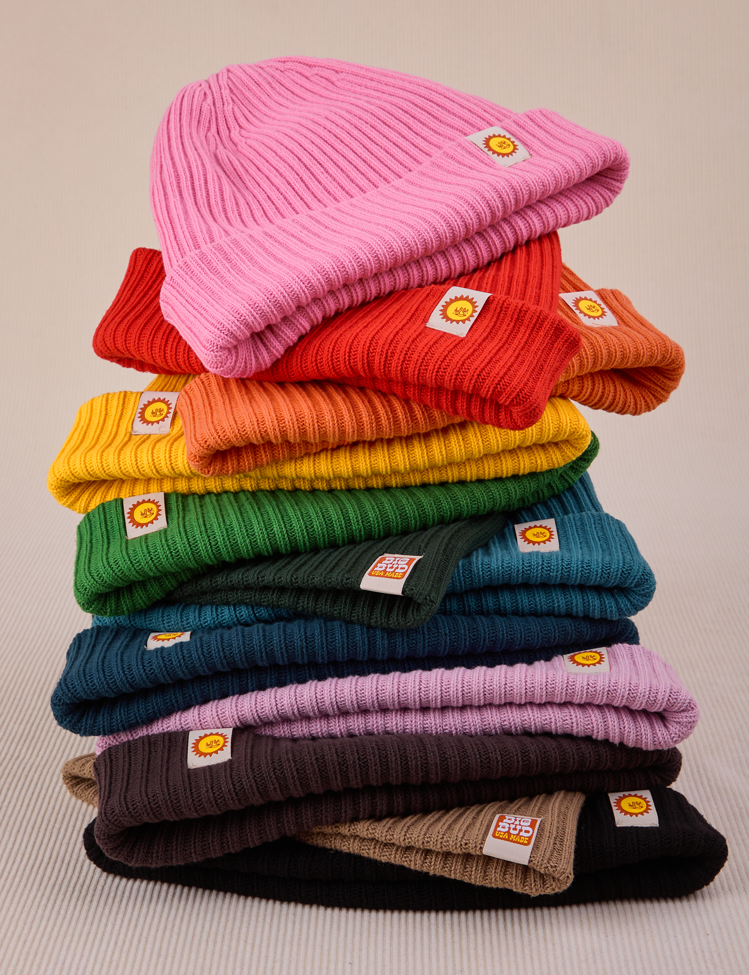 A stack of ribbed beanies in an array of colors