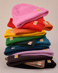 A stack of ribbed beanies in an array of colors