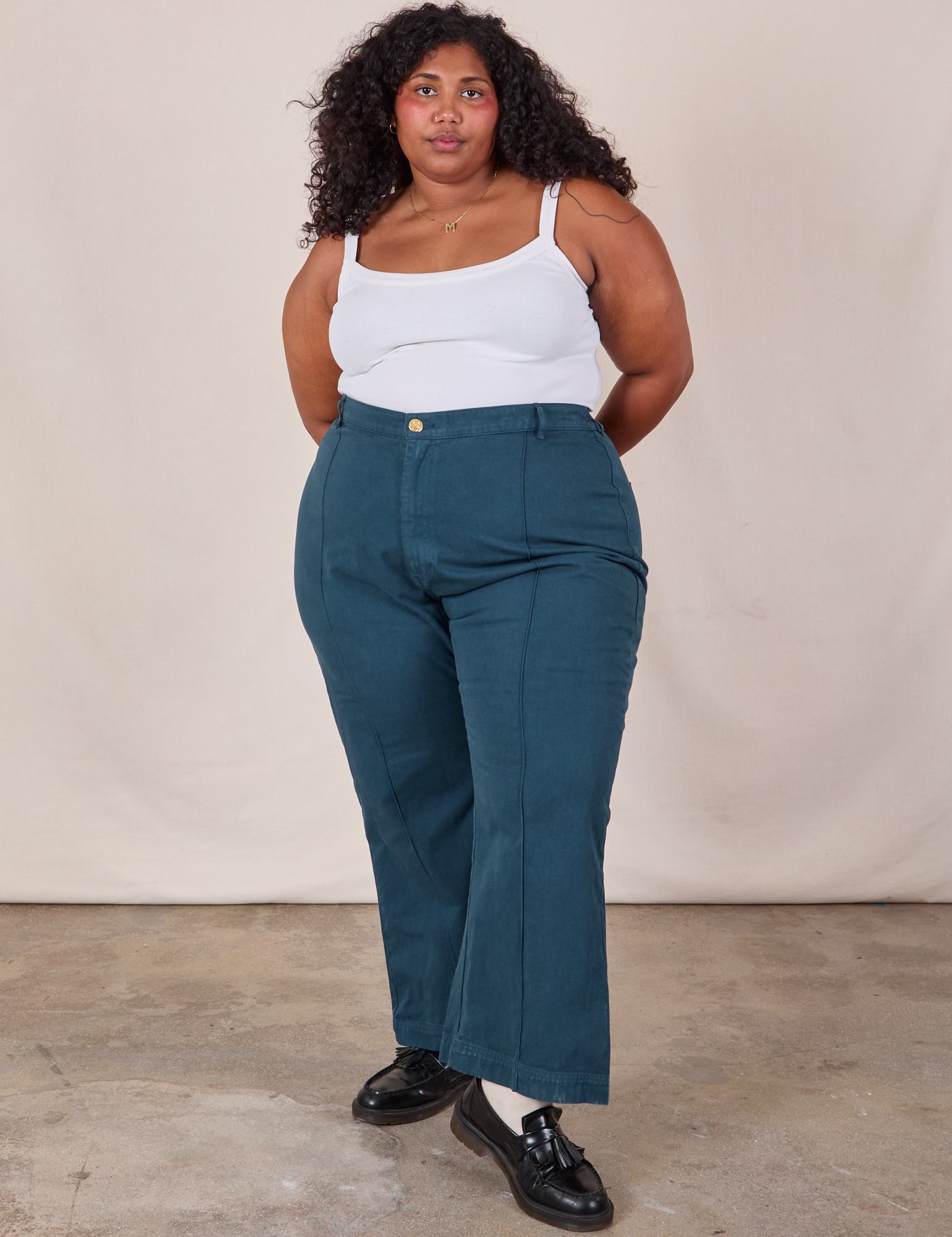 Morgan is 5'5" and wearing 2XL Western Pants in Lagoon paired with a Cropped Cami in Vintage Tee Off-White