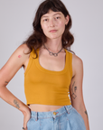 Alex is 5'8" and wearing P Cropped Tank Top in Mustard Yellow