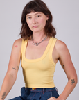 Alex is 5'8" and wearing P Cropped Tank Top in Butter Yellow