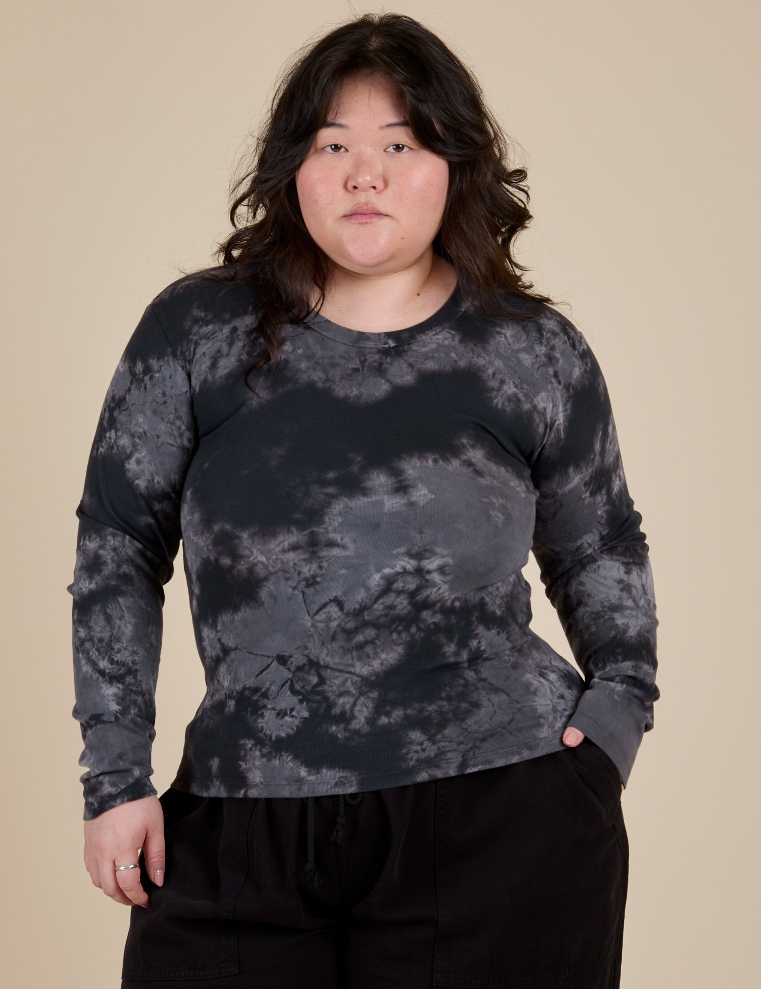 Ashley is 5’7” and wearing L Long Sleeve Baby Tee in Black Magic Waters